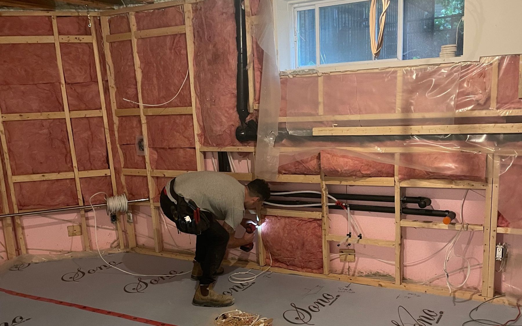 Framing, insulation and plumbing rough-in in a basement